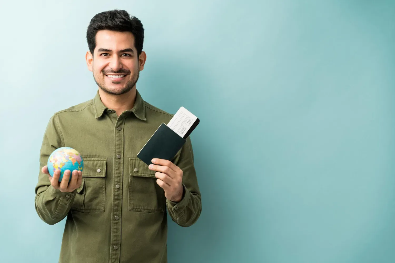 A smiling traveller holding a passport and a boarding pass