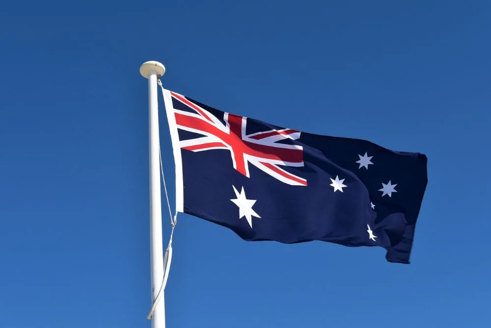 The Australian flag flying against a clear blue sky
