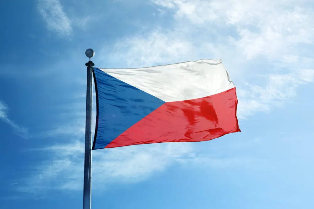 The Czech flag flying against a blue sky